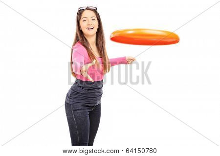 Beautiful woman throwing a Frisbee disk isolated on white background