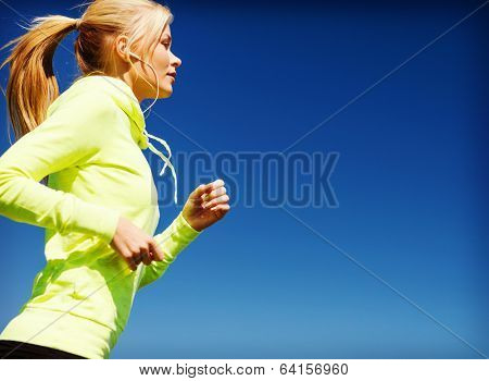 sport and lifestyle concept - woman doing running with earphones outdoors
