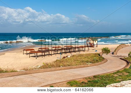 Walkway promenade along empty beach on Mediterranean sea in Ashkelon, Israel.