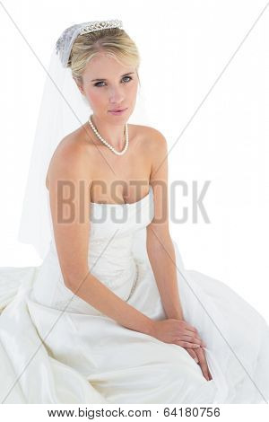 Portrait of young bride in off shoulder dress over white background