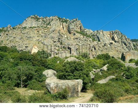 cliff and big rocks in flank of mountain