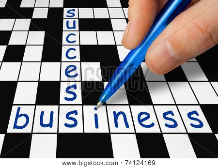 Hand filling in crossword - business and success
