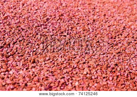 Closeup of red gravel texture, abstract background