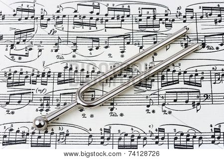 Pitchfork on sheet music, abstract art background