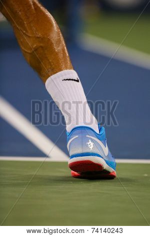 Seventeen times Grand Slam champion Roger Federer wears custom Nike tennis shoes during US Open 2014