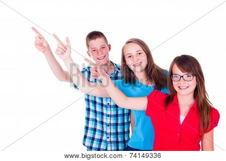 Happy Teenagers Pointing Up To Copy Space