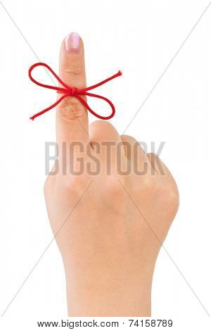 Red bow on finger isolated on white background