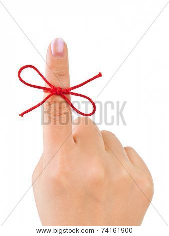 Red bow on finger isolated on white background