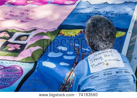 Woman Viewing Section Of Aids Quilt