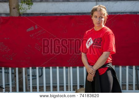 Emotional Young Woman Viewing Section Of The Aids Quilt