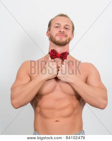 topless man wearing a red neckbow and smiling