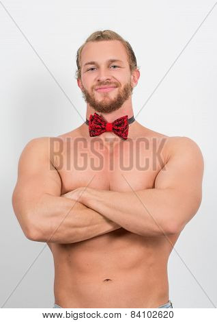 topless man wearing a red neckbow and smiling