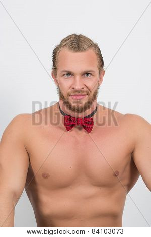 topless man wearing a red neckbow and smiling