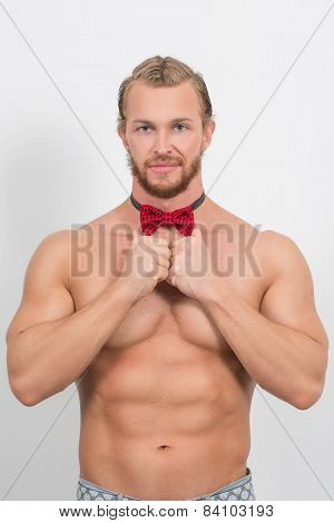 topless man wearing a red neckbow and smiling