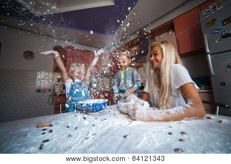 Mother With Kids On Kitchen
