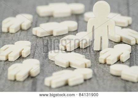 A wooden figure in a group of fallen