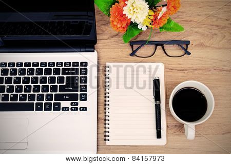 Laptop And Cup Of Coffee With Flower On Desk