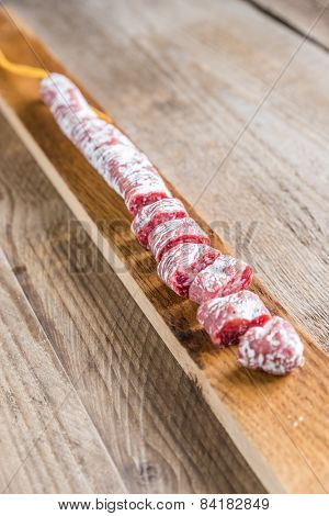 Cut Spanish Salami On The Wooden Board