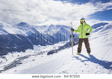 Young men with ski on a mountain winter resort