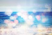 Background Of Blurred Beach And Sea Waves With Bokeh Lights
