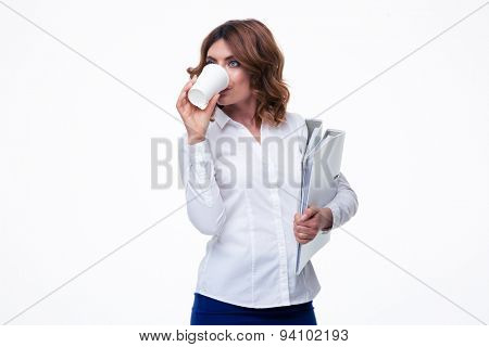 Businesswoman holding folders and drinking coffee isolated on a white background