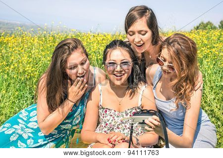 Multiracial Girlfriends At Countryside Picnic Watching Photos In Snapshot Instant Digital Camera