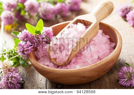 spa with pink herbal salt and clover flowers