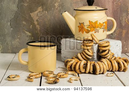 Old Tea Enamelware And Dry Bagels With Poppy