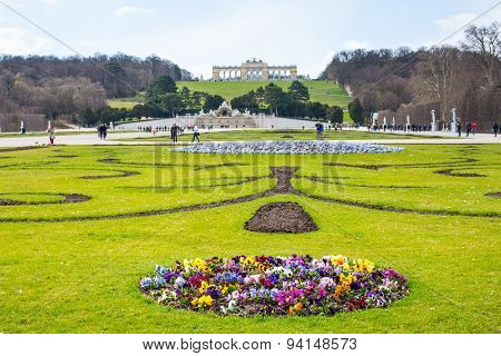 Flowerbed, Tourists, Neptune Fountain and Gloriette at Schonbrunn, Vienna, Austria