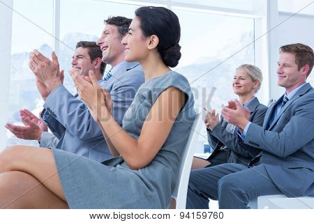 Business people applauding during meeting in office