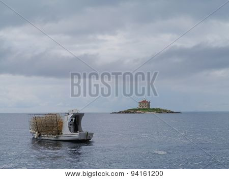 The island Trstenik with a fishing vessel