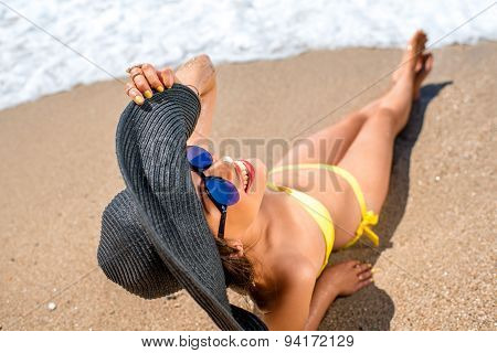Woman engoying sun and water on the beach