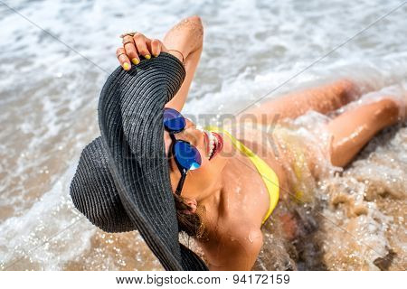 Woman engoying sun and water on the beach