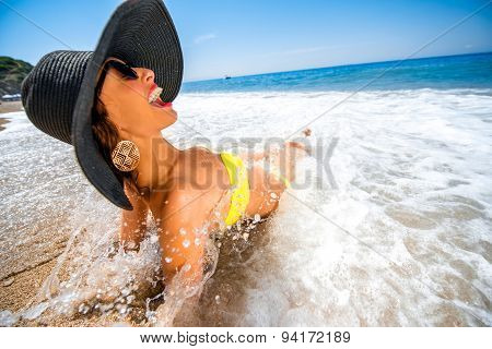 Woman engoying sun and water on the beach