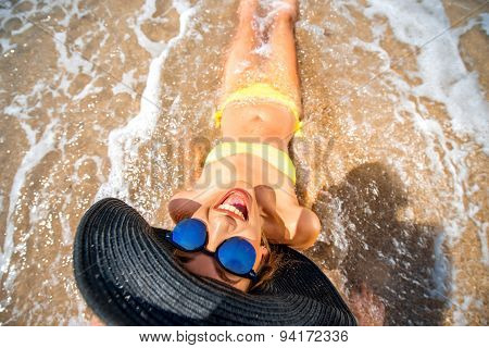 Woman engoying sun and water on the beach