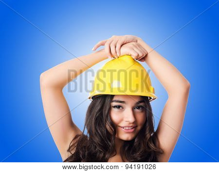 Young woman with hellow hard hat against gradient 