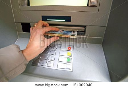 Young Woman While She Getting Money From Atm
