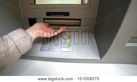 Hand Of Woman While Waiting The Money From Atm