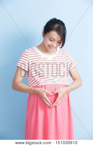 pregnant woman is smile isolated on bluebackground asian