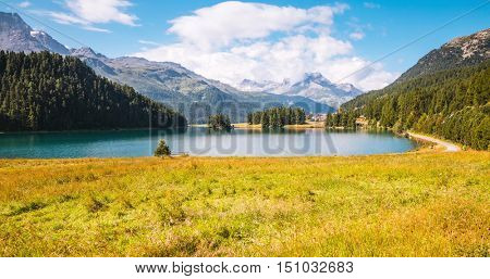 Great view of the azure pond Champfer in alpine valley. Popular tourist attraction. Picturesque and gorgeous scene. Location Swiss alps, Silvaplana village, district of Maloja, Europe. Beauty world.