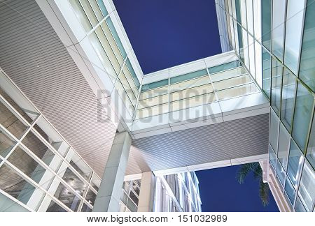 Office buildings stretch up to the blue sky in the financial district in downtown Putrajaya Malaysia.