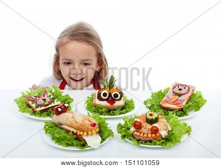 Happy child in awe finding the creative creature sandwiches - isolated with copy space