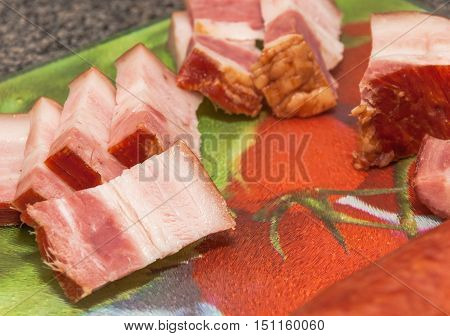 Bacon cut into slices over board. Preparing ingredient.