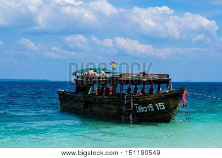 KRABI - JANUARY 19, 2015 : People on the boat to Railay Beach in Krabi, Thailand on a sunny day JANUARY 20, 2015. Railay Beach is a small peninsula with white sand beaches, soaring limestone cliffs, viewpoints, caves and a lagoon hidden inside the cliffs,