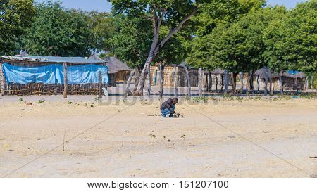 Caprivi, Namibia - August 20, 2016: Poor Teenager Playing On The Roadside In The Rural Caprivi Strip