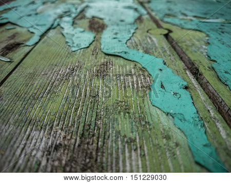 Wood background with old green peeling paint, horizontal view