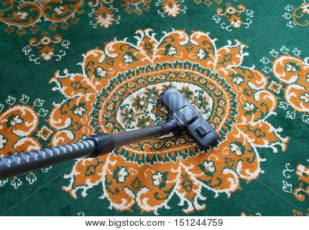 Carpet vacuuming with vacuum cleaner at home