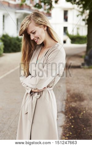 Beautiful woman in park overcoat smiling autumn season