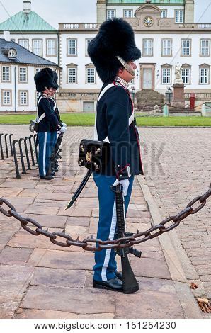 Fredensborg Denmark - August 6 2010: Royal guards changing on Fredensborg palace at August 6 2010 in Fredensborg Denmark - in nasty weather.