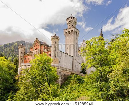 Neuschwanstein Castle is a nineteenth-century Romanesque Revival palace on a rugged hill above the village of Hohenschwangau near Fussen in southwest Bavaria Germany.